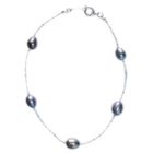BRACELET - GOURMETTE Bracelet de perles noires montées sur un fil de…