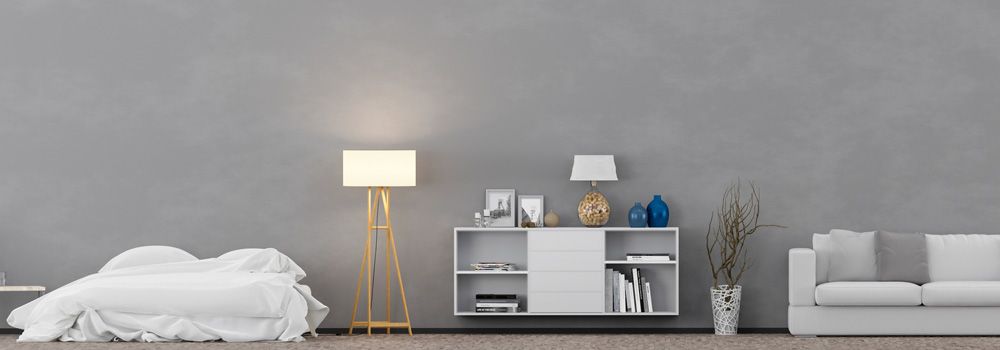 lit avec linge de lit blanc, lampadaire, meuble étagère blanc, canapé blanc, vase