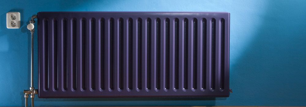 radiateur de couleur violet sur mur bleu