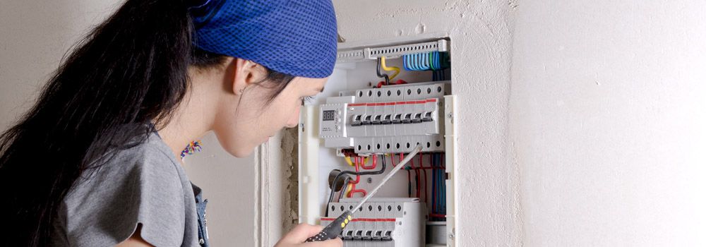 femme réparant l'installation électrique